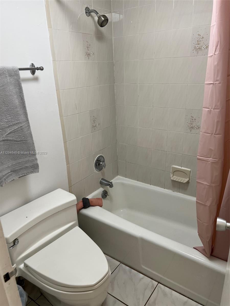 100 Lincoln Road, Unit 1001 Miami Beach, FL 33139 - Photo 19 of 62 a white toilet and tub sitting next to a bathroom sink