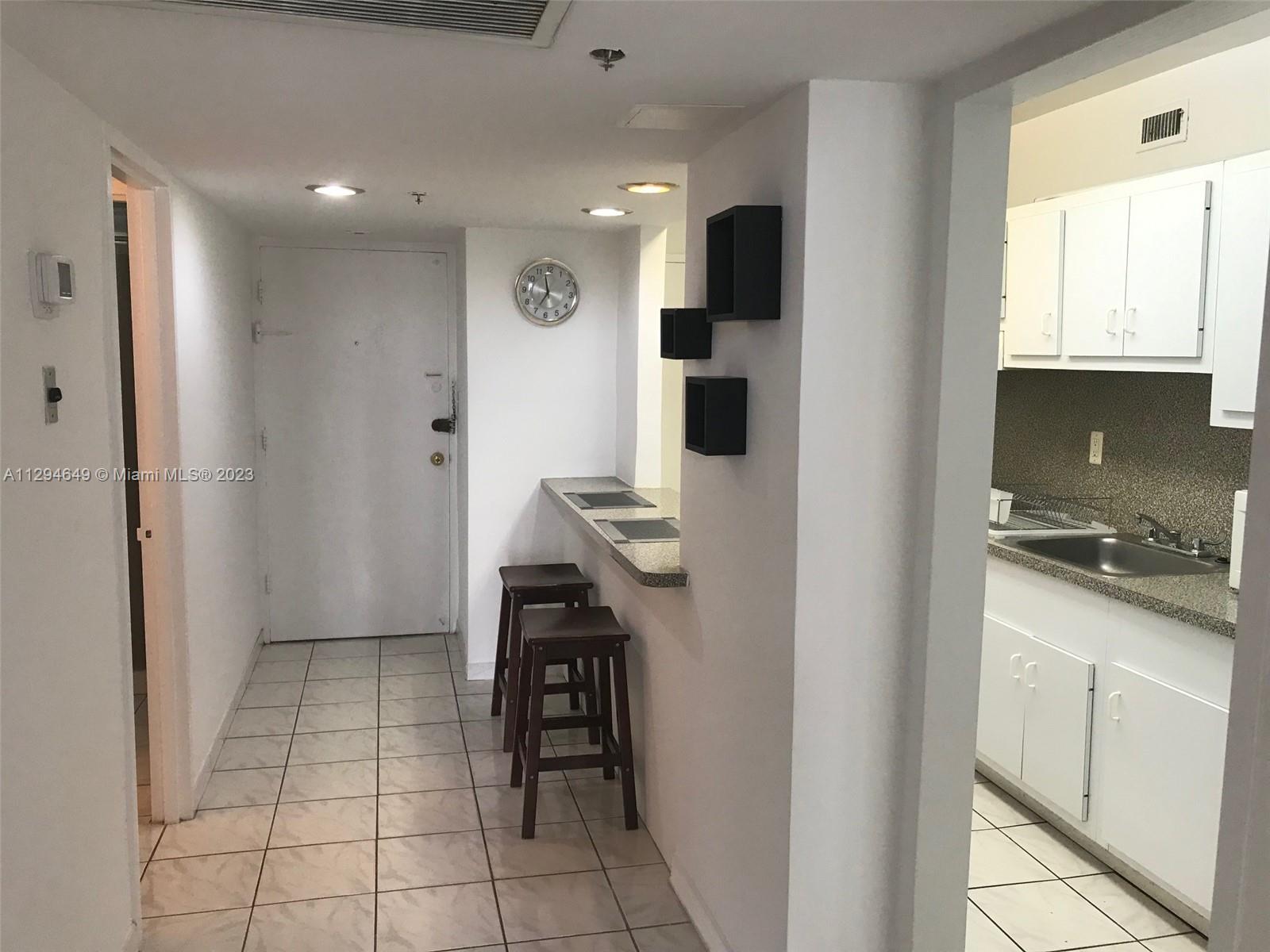100 Lincoln Road, Unit 1001 Miami Beach, FL 33139 - Photo 3 of 62 a kitchen with stainless steel appliances kitchen island granite countertop a refrigerator and a sink