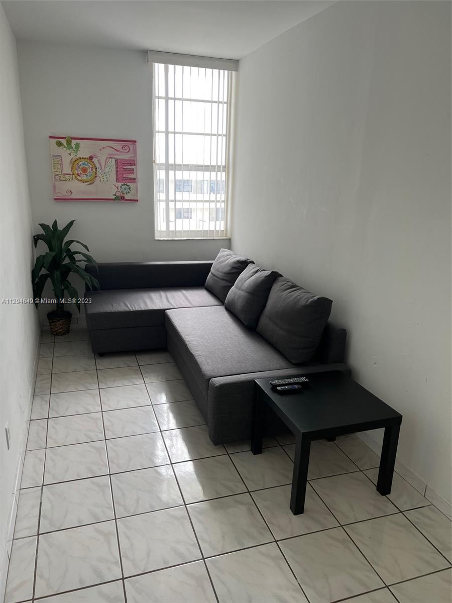 100 Lincoln Road, Unit 1001 Miami Beach, FL 33139 - Photo 4 of 62 a living room with furniture and a window