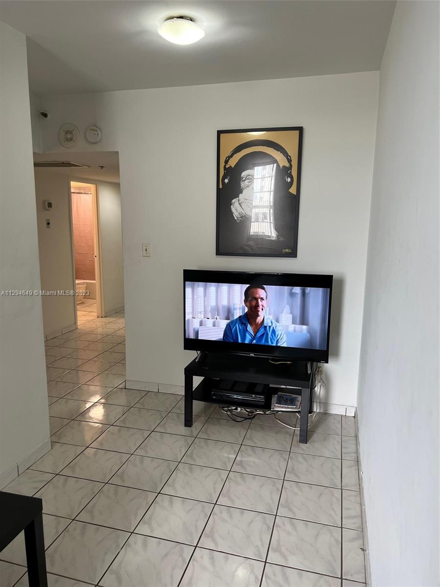 100 Lincoln Road, Unit 1001 Miami Beach, FL 33139 - Photo 6 of 62 a living room with furniture and a flat screen tv