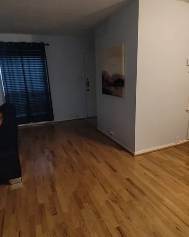 a view of hallway with wooden floor