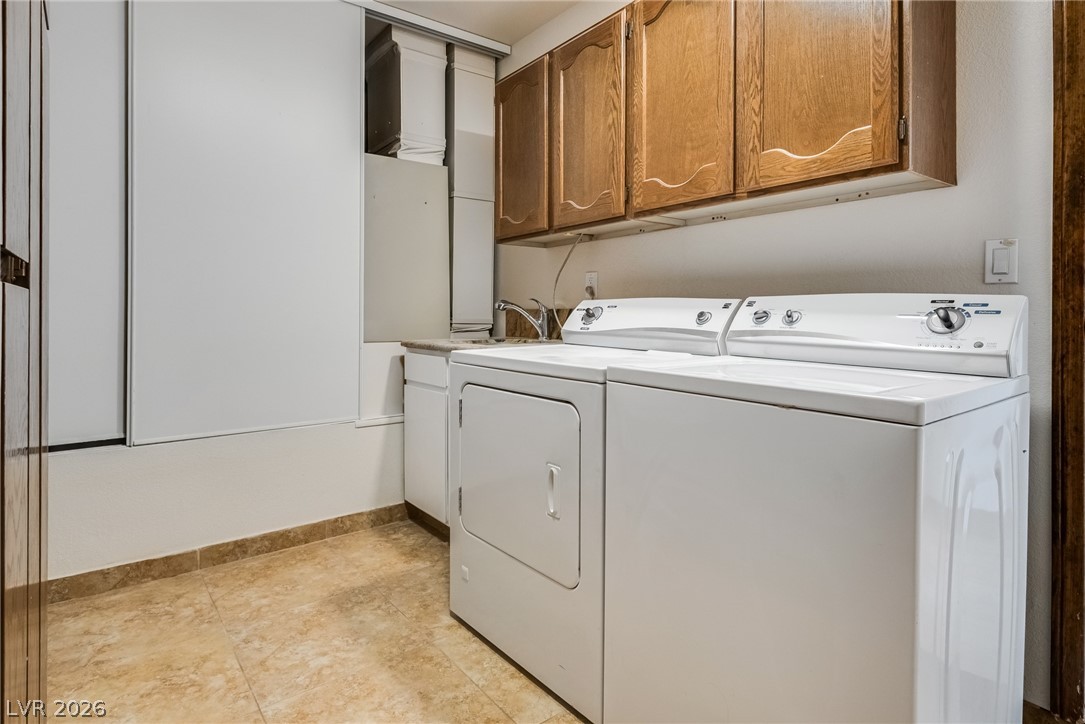 524 Swallow Cove Boulder City, NV 89005 - Photo 34 of 58 Functional laundry room equipped with upper cabinetry and a convenient utility sink.