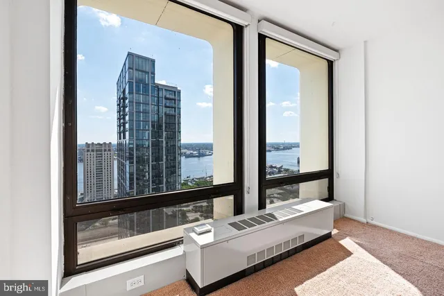 a room with furniture and large windows