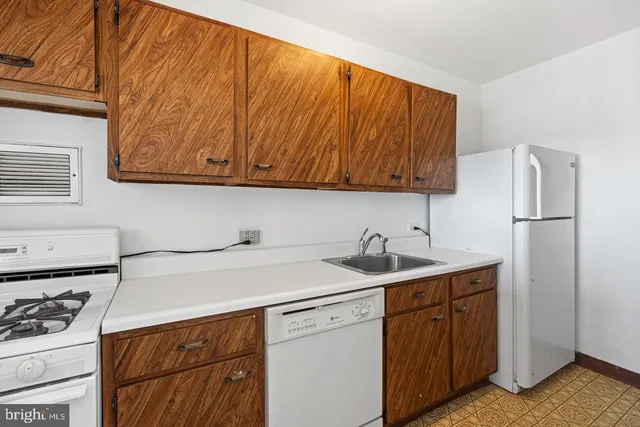 a kitchen with a sink cabinets and appliances
