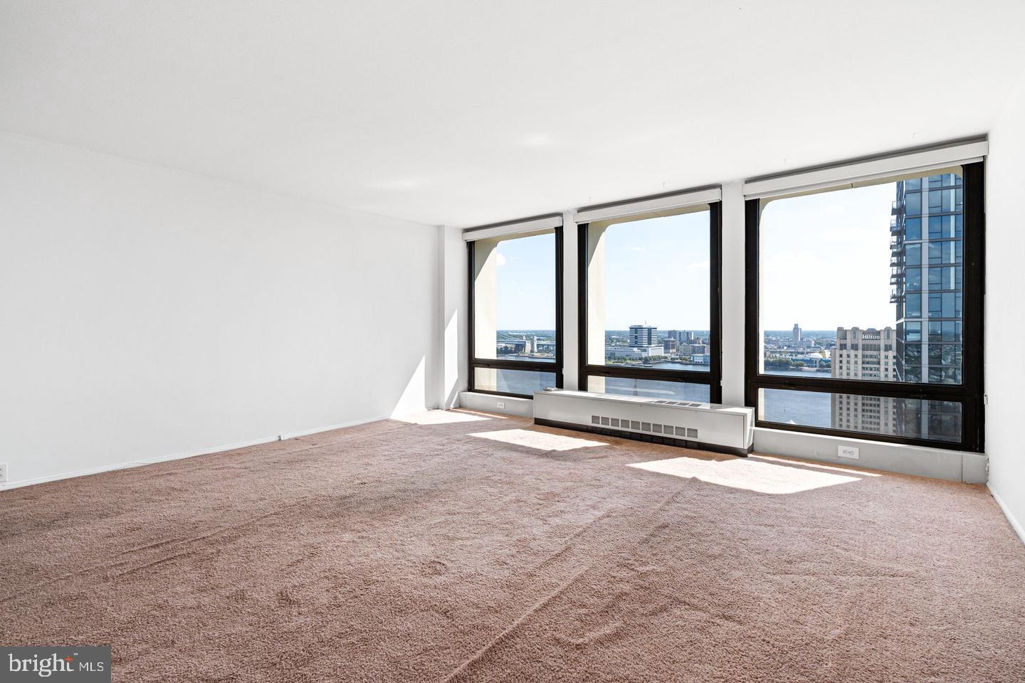 200 Locust Street, Unit 27FN Philadelphia, PA 19106 - Photo 6 of 48 an empty room with wooden floor and sliding door