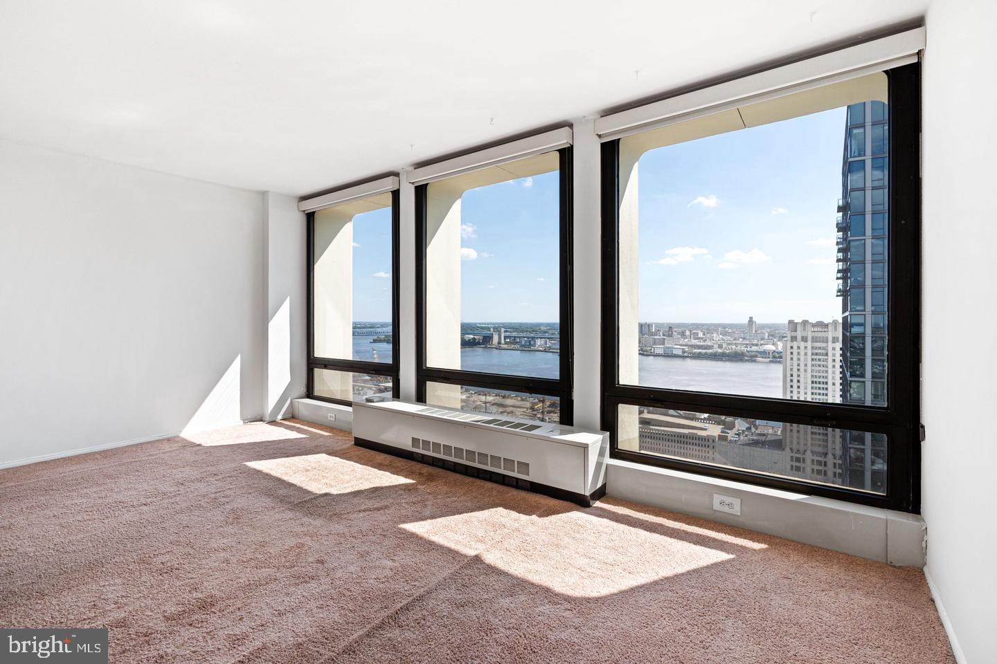 200 Locust Street, Unit 27FN Philadelphia, PA 19106 - Photo 7 of 48 a living room with a large window and a rug