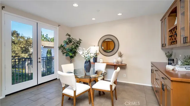 a dining room with furniture and a mirror