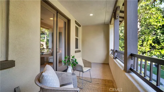a potted plant sitting in front of a door with a bench