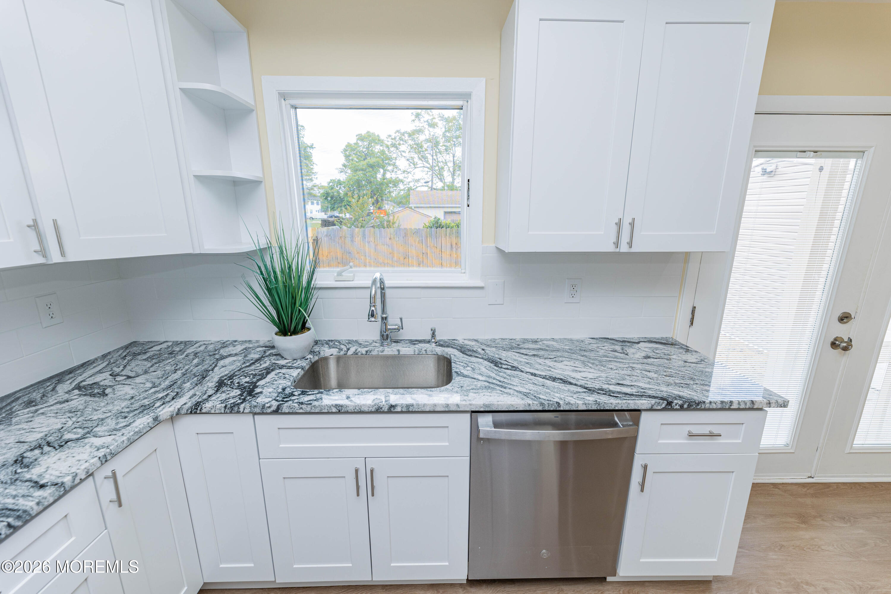 2408 Herbertsville Road Point Pleasant, NJ 08742 - Photo 7 of 82 a kitchen with granite countertop a sink white cabinets and white countertops with wooden floor