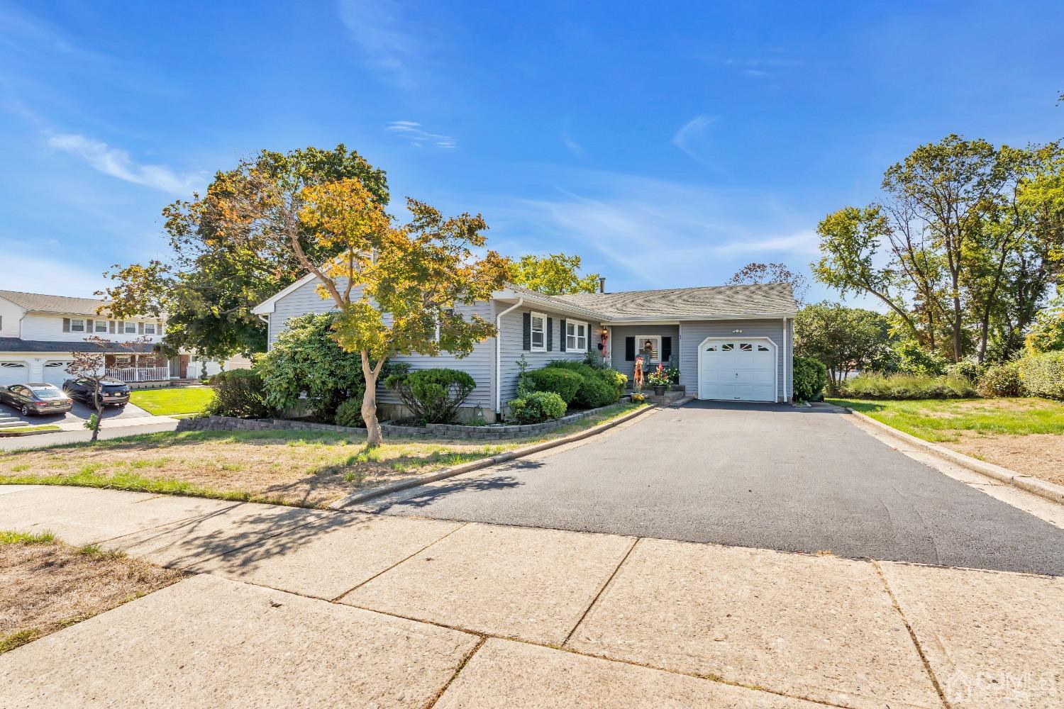 a view of a house with a yard and a garage