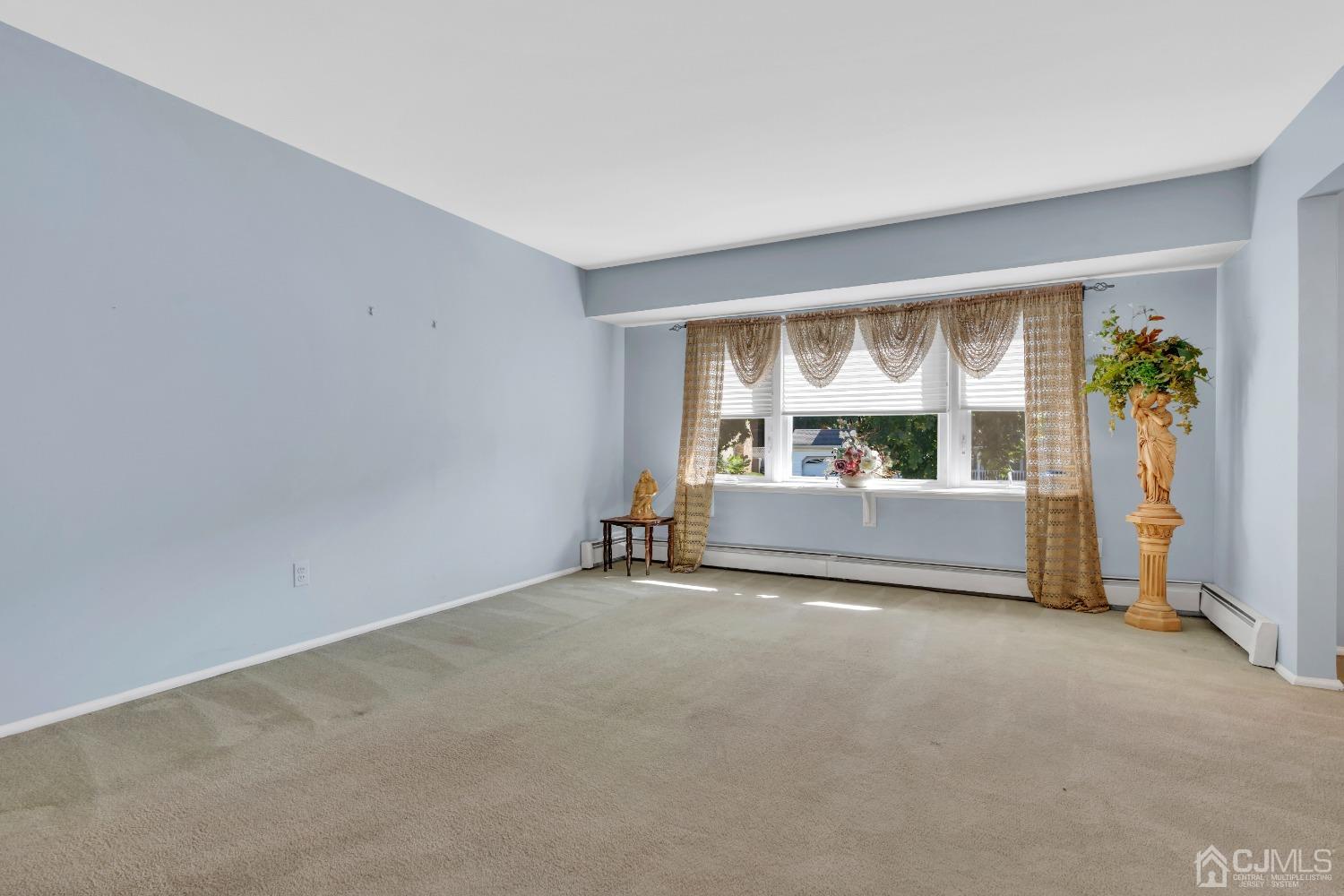1 Robinhood Drive Sayreville, NJ 08859 - Photo 16 of 29 a view of an empty room with a window and a kitchen