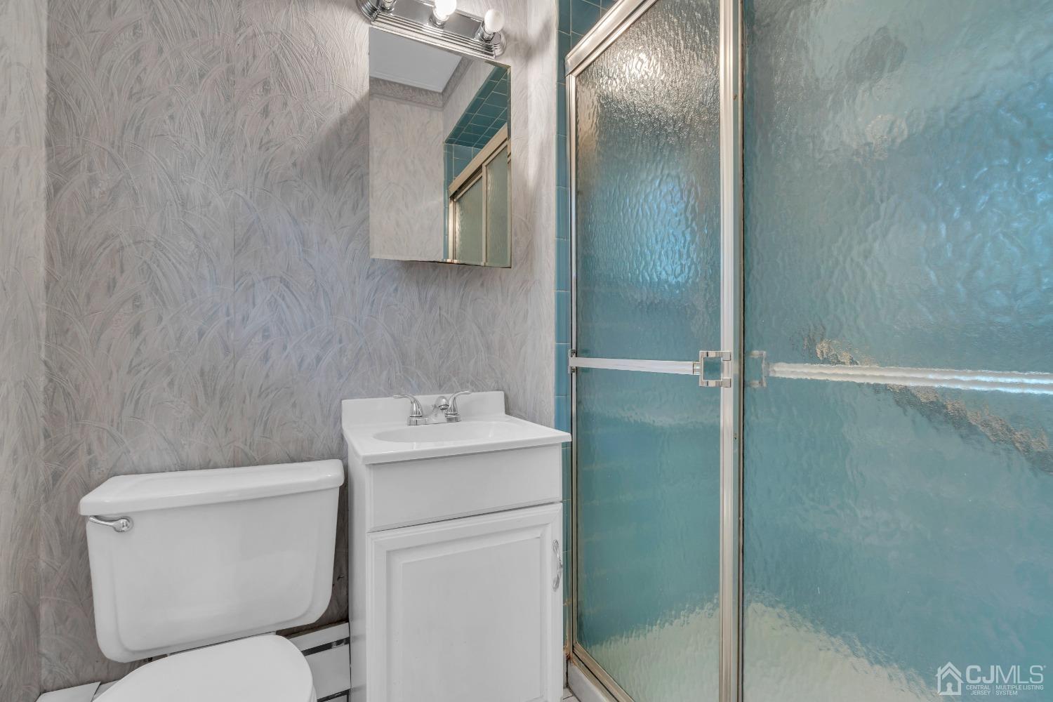 1 Robinhood Drive Sayreville, NJ 08859 - Photo 21 of 29 a bathroom with a toilet sink and mirror