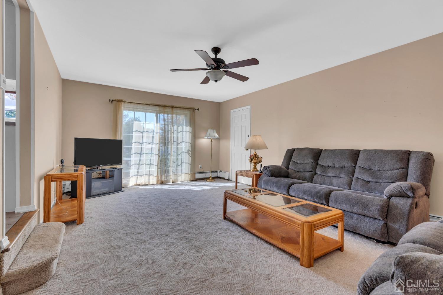1 Robinhood Drive Sayreville, NJ 08859 - Photo 7 of 29 a living room with furniture a flat screen tv and a large window