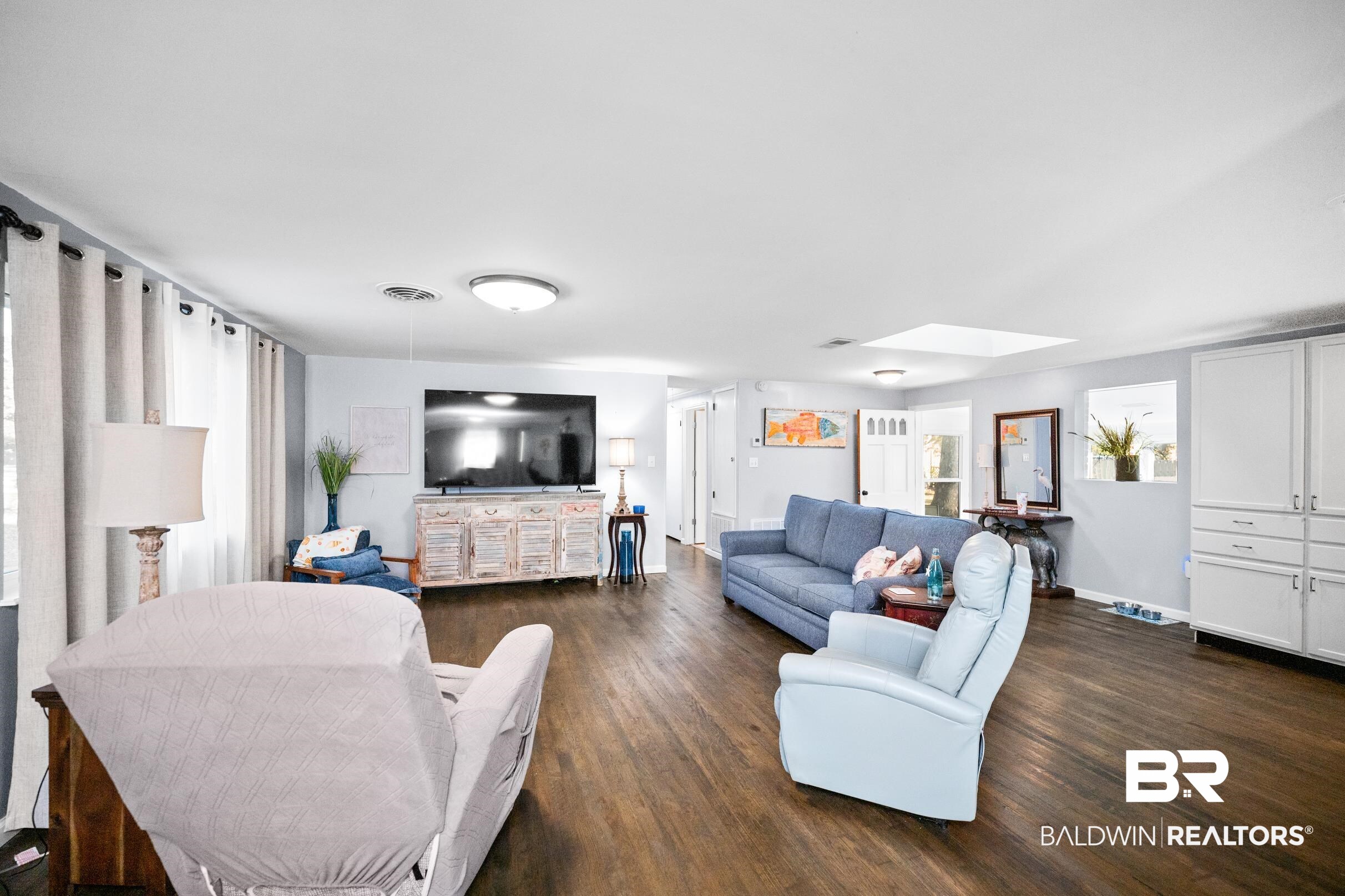 401 West Myrtle Avenue Foley, AL 36535 - Photo 11 of 39 Living room with dark wood finished floors and a skylight