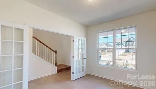 a view of an empty room with windows