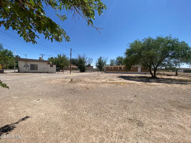 a view of a road with a house in the background