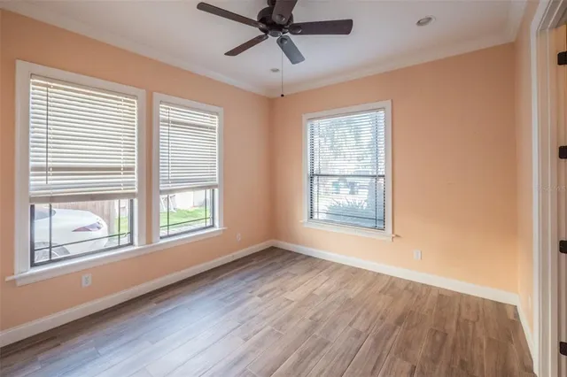 wooden floor in an empty room with a window