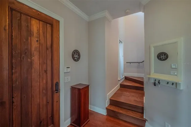a spacious bedroom with a bed and wooden floor