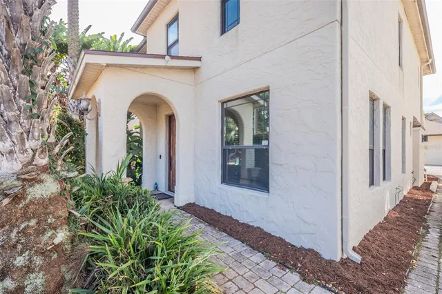 a view of a hallway with wooden floor and a livingroom