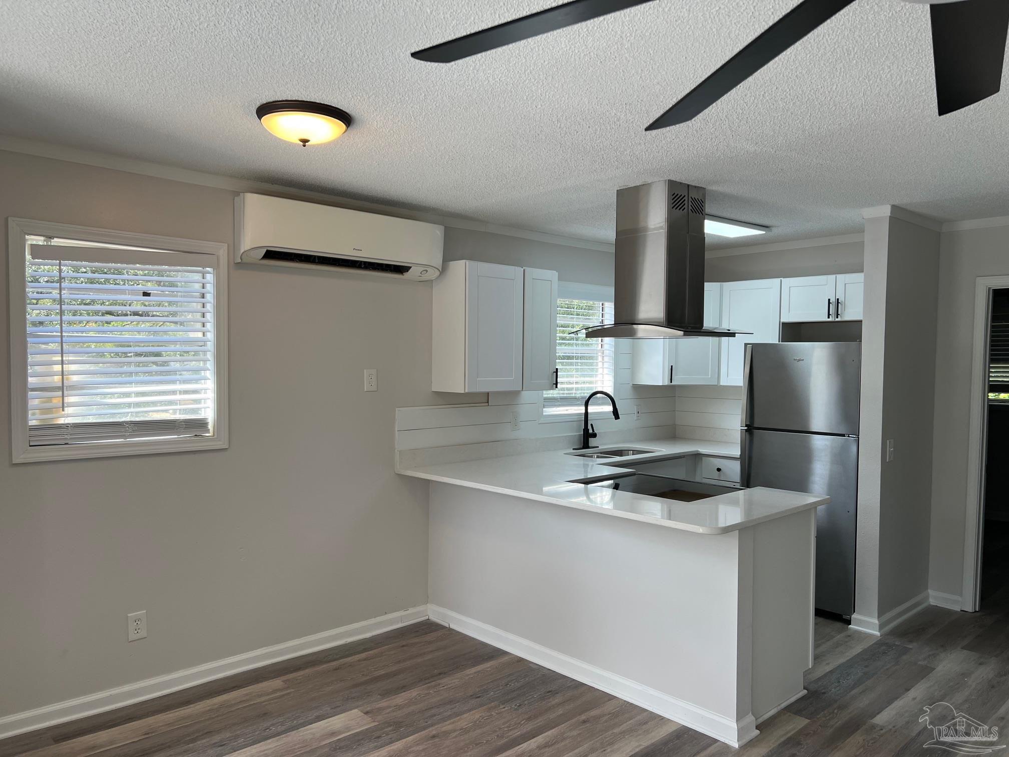 6642 Applegate Street Milton, FL 32570 - Photo 6 of 10 a kitchen with kitchen island a sink appliances and cabinets