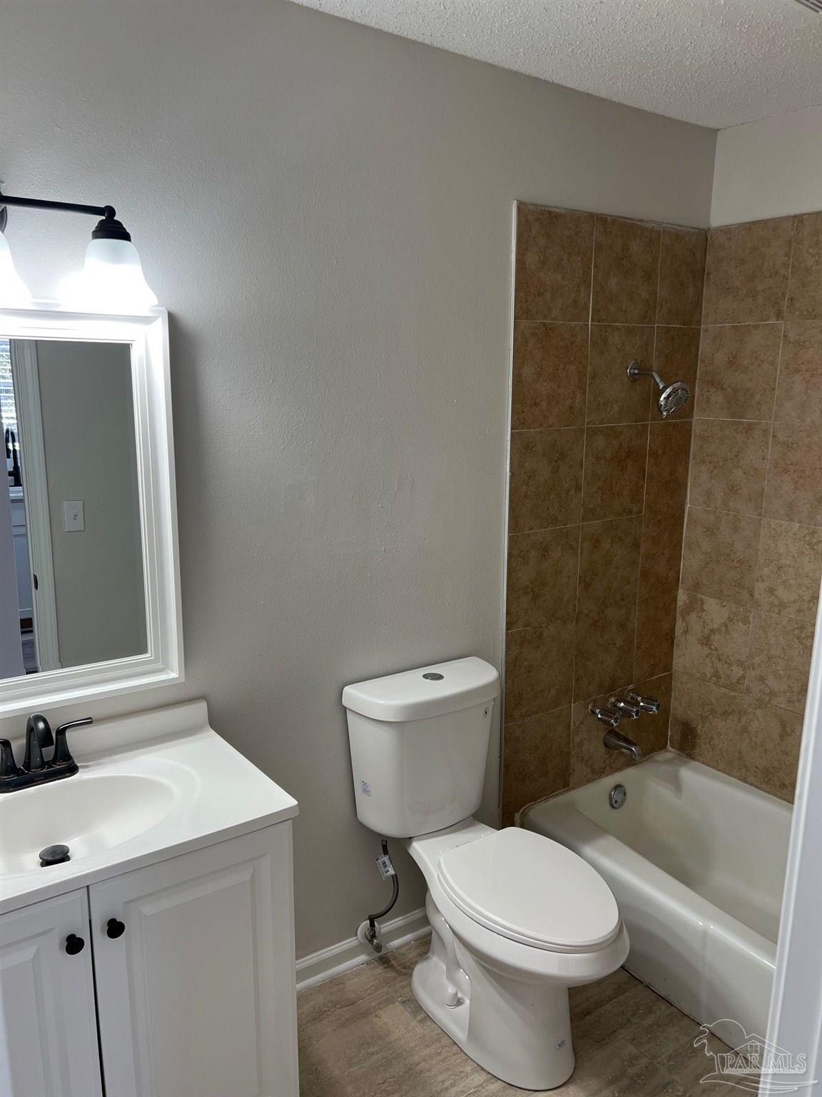6642 Applegate Street Milton, FL 32570 - Photo 9 of 10 a bathroom with a sink toilet and shower