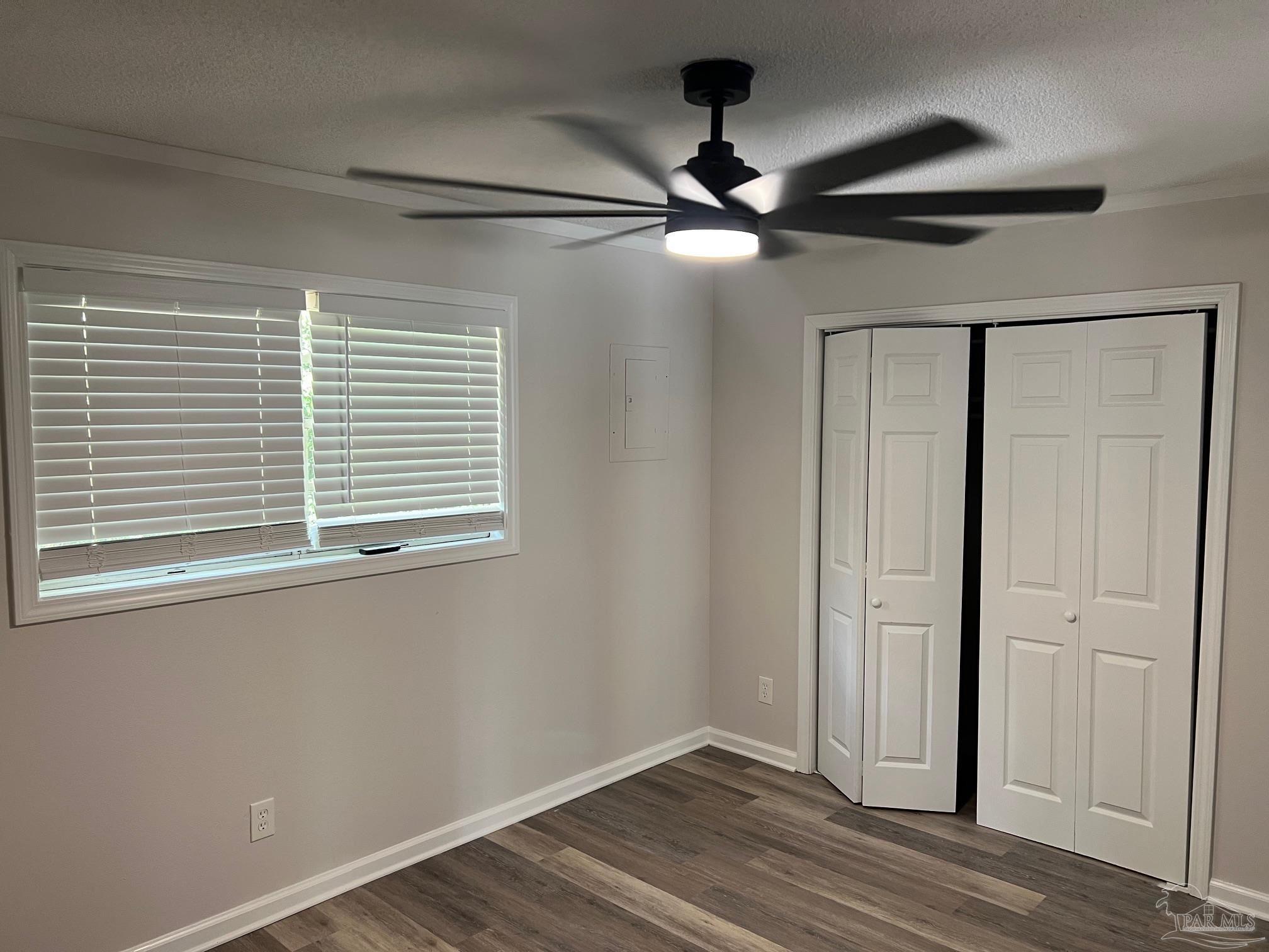 6642 Applegate Street Milton, FL 32570 - Photo 10 of 10 a view of an empty room with wooden floor and a window