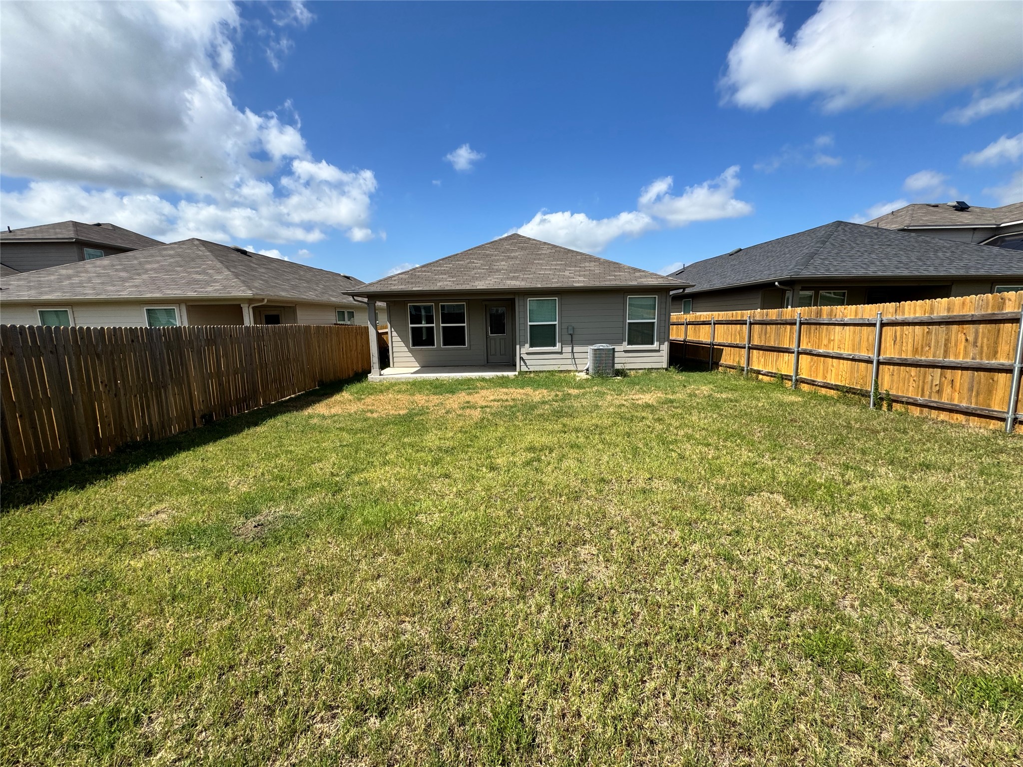 11820 Rush Lane Elgin, TX 78621 - Photo 29 of 31 Fenced backyard offering ample green space and a private setting for outdoor activities.