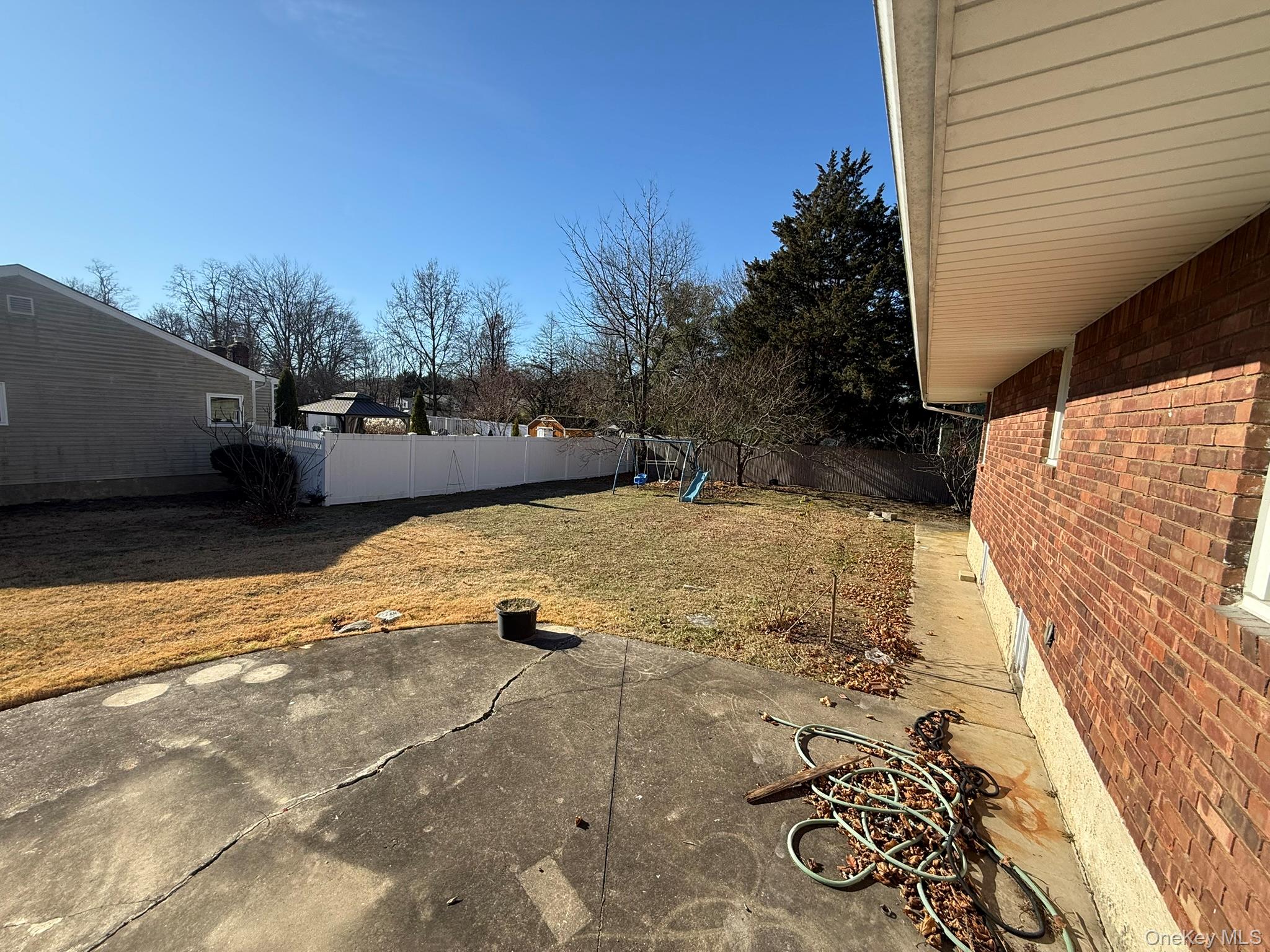 24 Poplar Place Bay Shore, NY 11706 - Photo 9 of 10 Fenced backyard with a patio