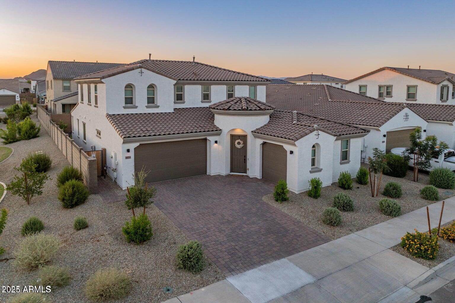 14274 West Sand Hills Road Surprise, AZ 85387 - Photo 1 of 24 a front view of a house with a yard and potted plants
