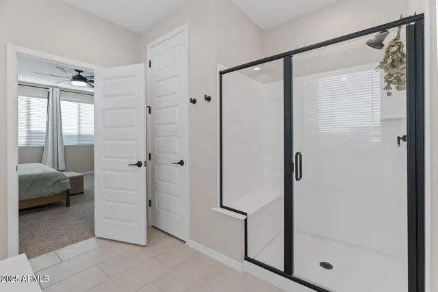 a bathroom with a shower and a glass door