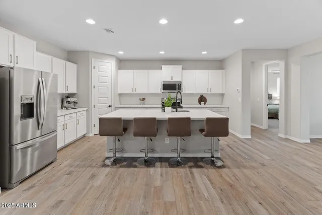 a large kitchen with a table and chairs