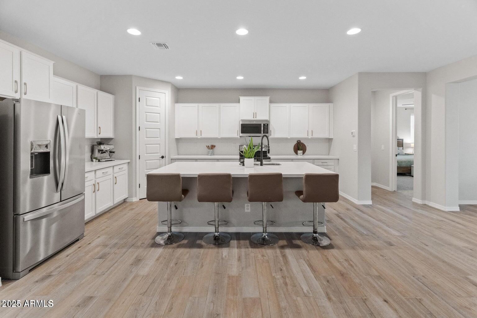 14274 West Sand Hills Road Surprise, AZ 85387 - Photo 14 of 24 a large kitchen with a table and chairs
