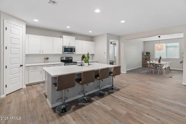 a kitchen with a sink stove and cabinets