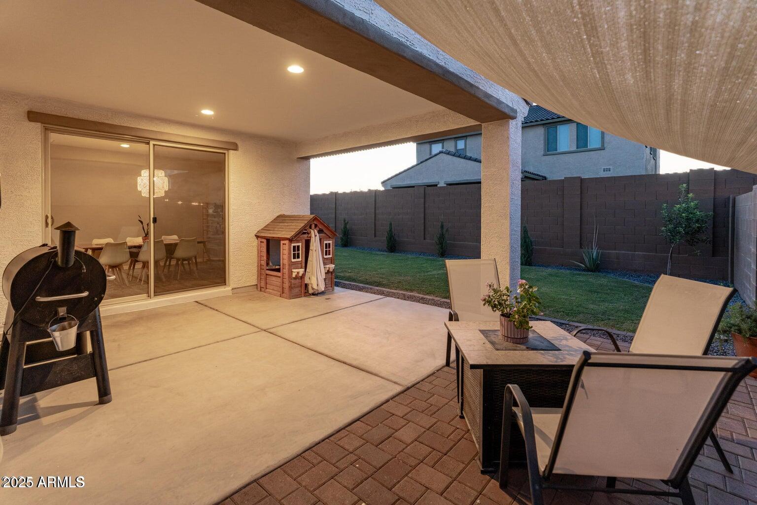 14274 West Sand Hills Road Surprise, AZ 85387 - Photo 19 of 24 a patio with yard a couch and chairs
