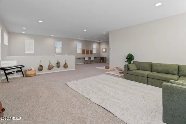 a living room with furniture and kitchen view