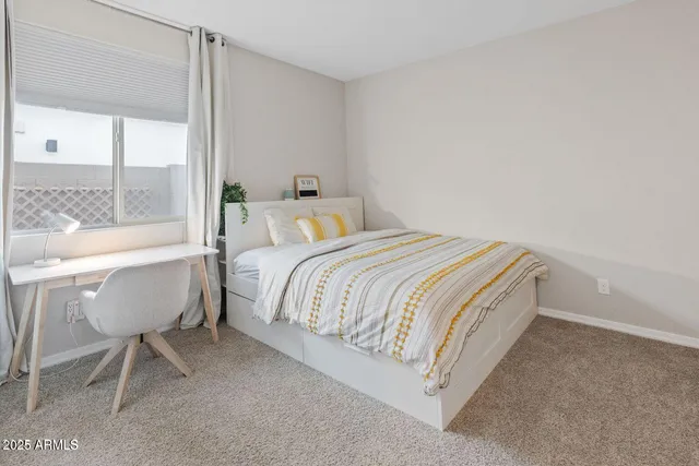 a bedroom with a bed and a table