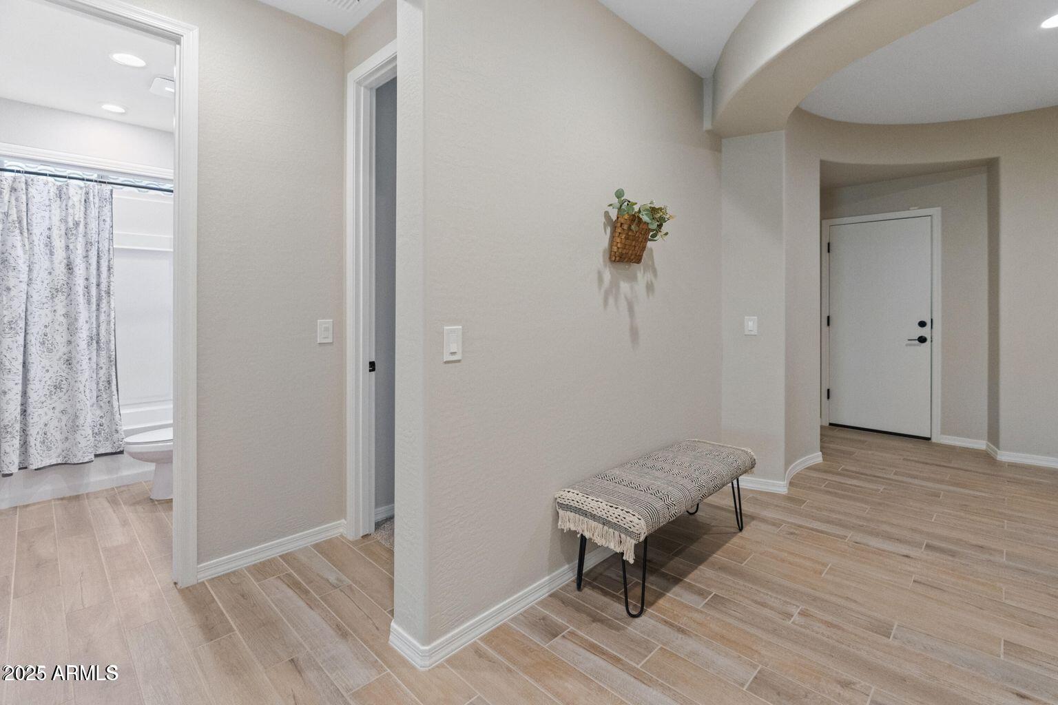 14274 West Sand Hills Road Surprise, AZ 85387 - Photo 7 of 24 a view of a hallway with wooden floor and staircase