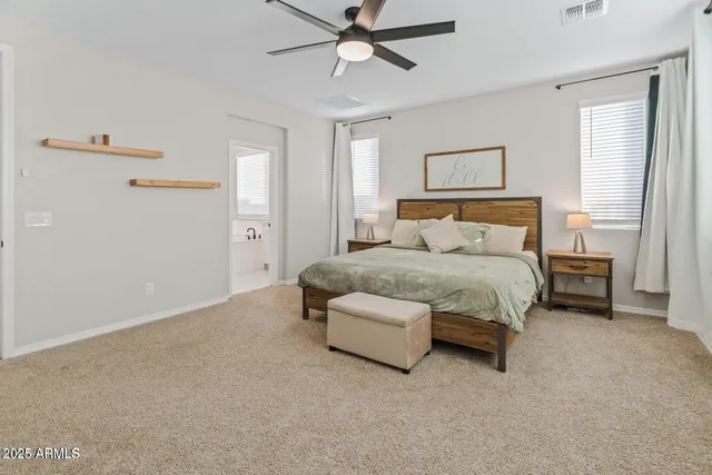 a bedroom with a bed and ceiling fan
