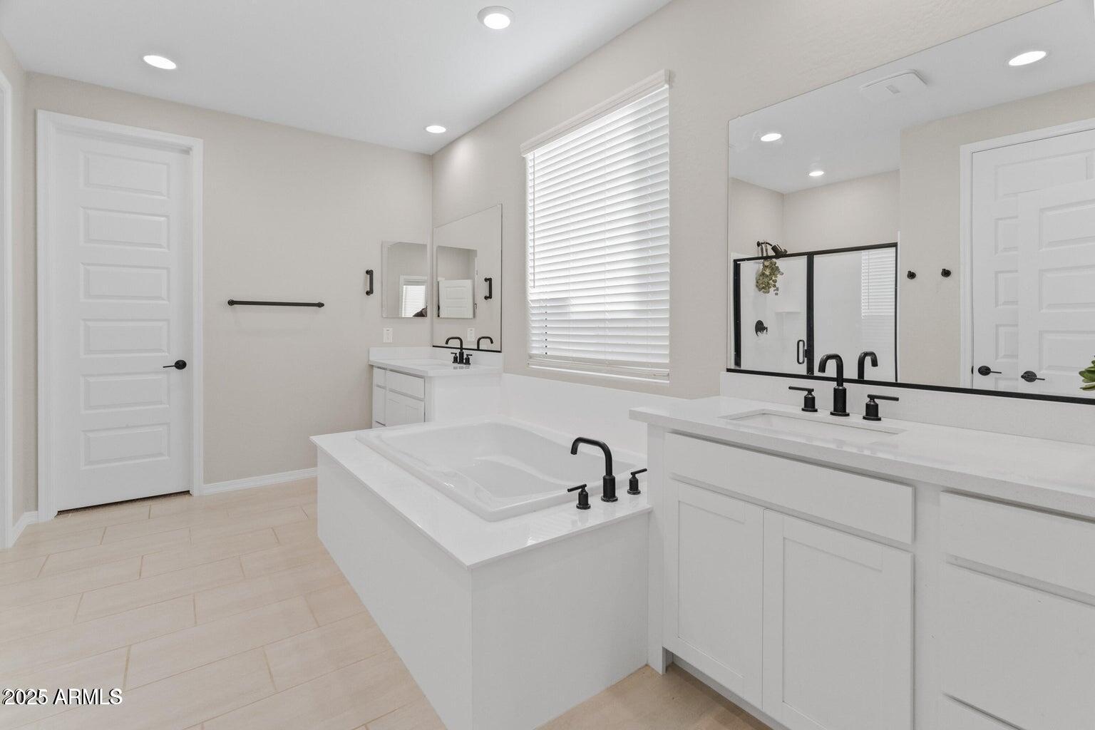 14274 West Sand Hills Road Surprise, AZ 85387 - Photo 10 of 24 a bathroom with a sink a tub and a mirror