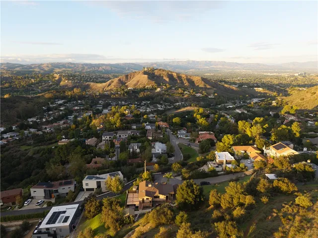 an aerial view of residential building and trees around