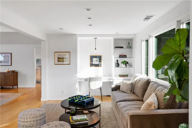 a living room with furniture potted plant and a window