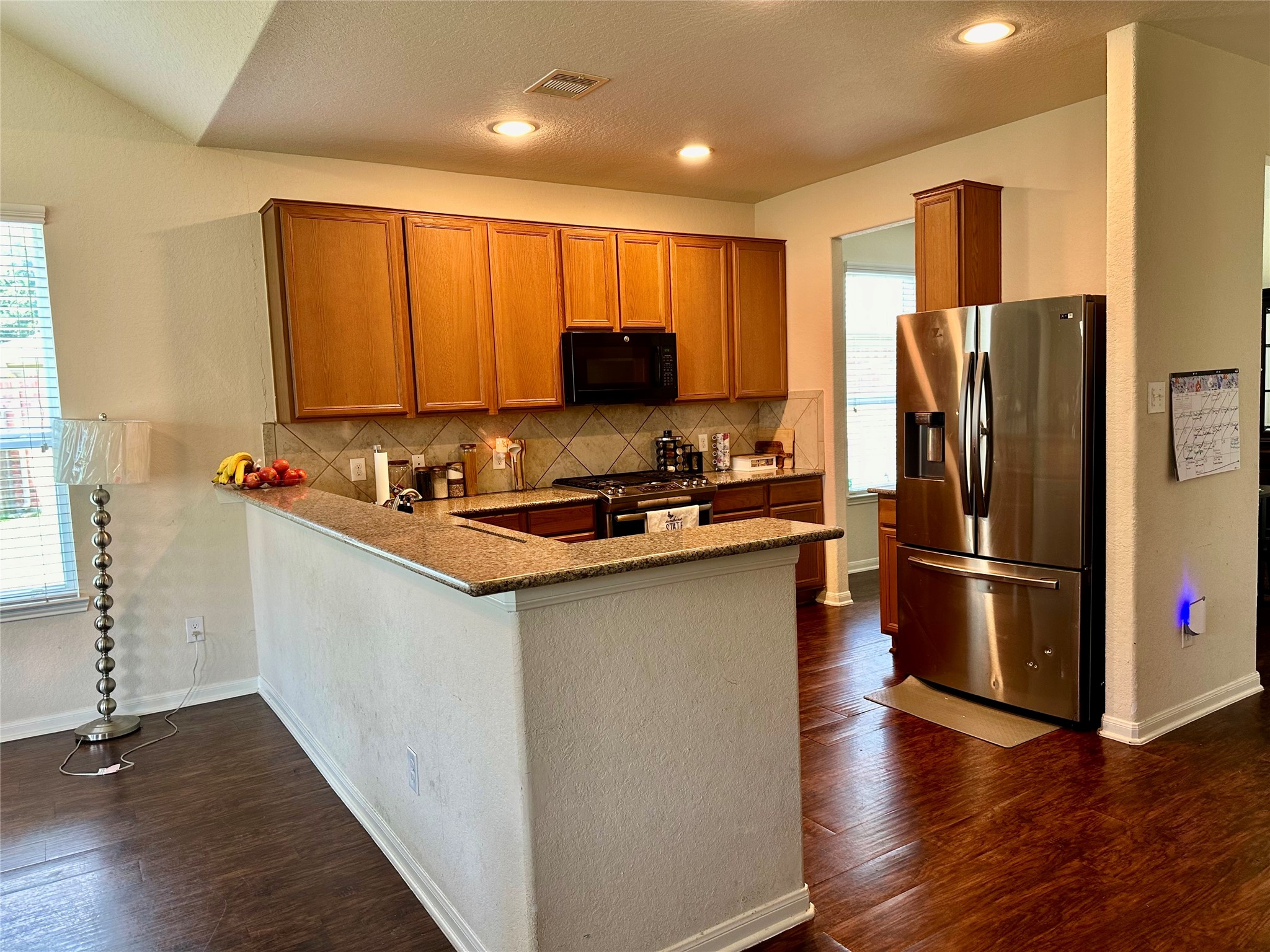18622 Each Elm Way Houston, TX 77084 - Photo 5 of 35 a kitchen with stainless steel appliances a refrigerator stove microwave and sink
