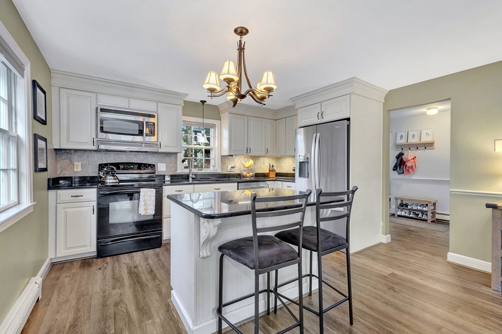 14 Hanson Street Dedham, MA 02026 - Photo 11 of 41 a kitchen with granite countertop wooden floors and stainless steel appliances
