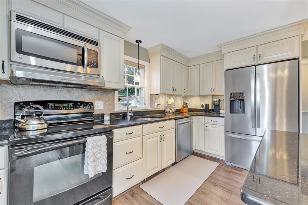 14 Hanson Street Dedham, MA 02026 - Photo 16 of 41 a kitchen with cabinets stainless steel appliances and a counter space