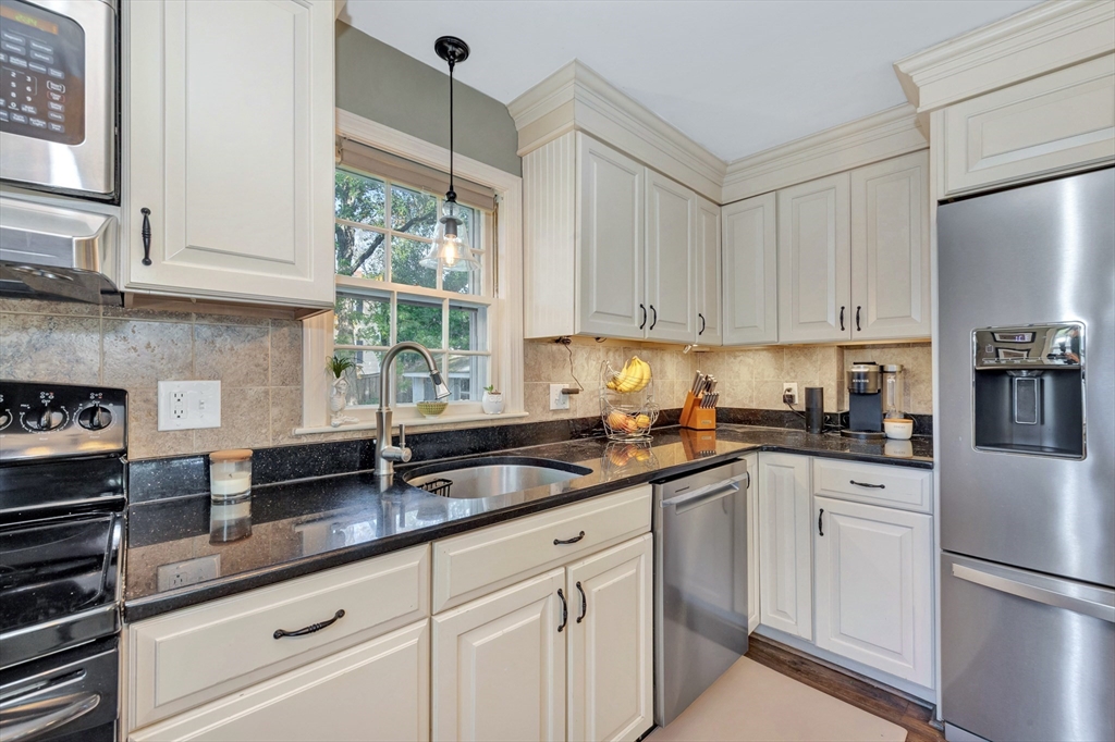 14 Hanson Street Dedham, MA 02026 - Photo 17 of 41 a kitchen with granite countertop white cabinets white appliances and sink