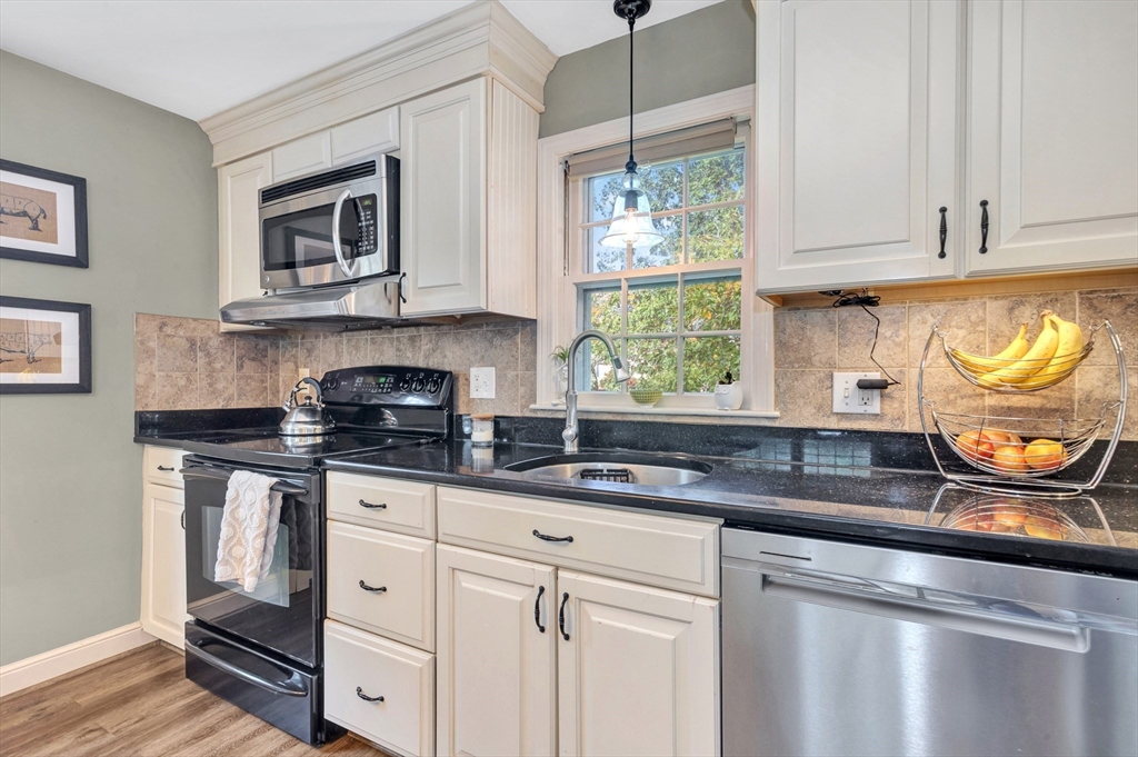 14 Hanson Street Dedham, MA 02026 - Photo 18 of 41 a kitchen with stainless steel appliances granite countertop a sink and a stove