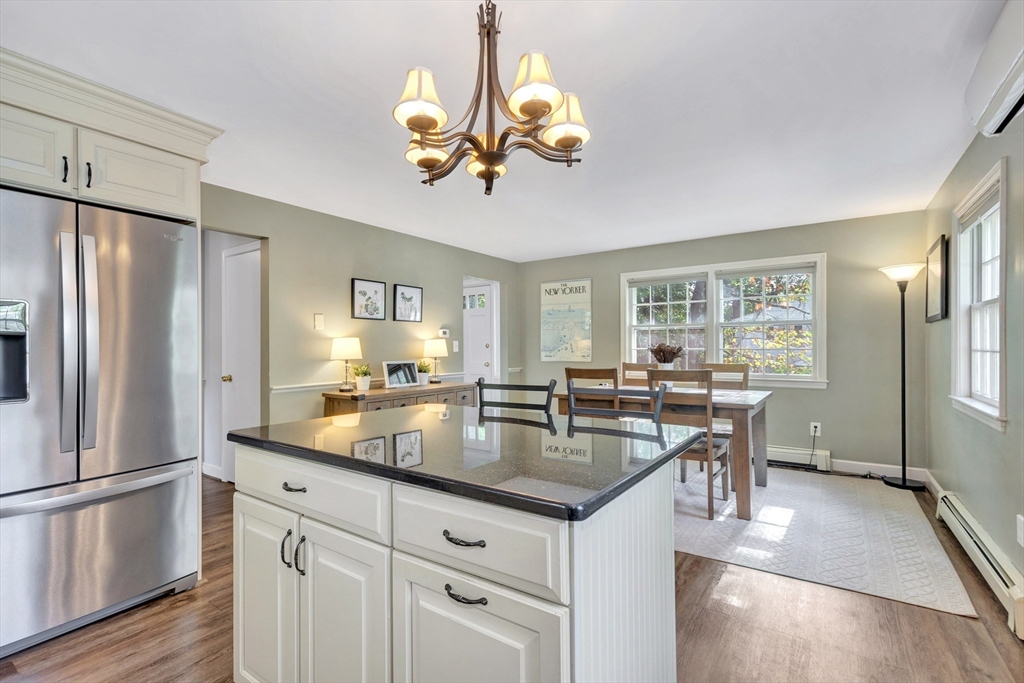 14 Hanson Street Dedham, MA 02026 - Photo 21 of 41 a kitchen with stainless steel appliances granite countertop a refrigerator a sink dishwasher a dining table and chairs with wooden floor