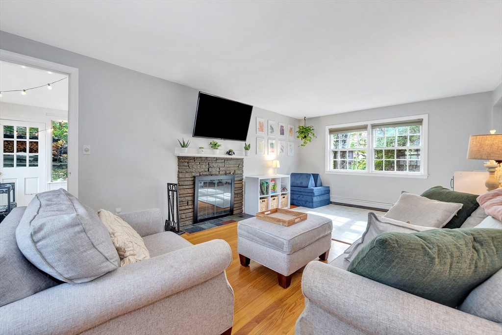 14 Hanson Street Dedham, MA 02026 - Photo 22 of 41 a living room with furniture a flat screen tv and a fireplace