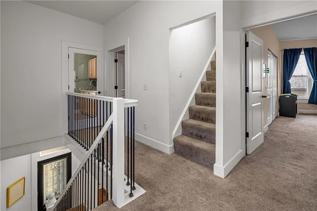 a view of entryway and hall with wooden floor