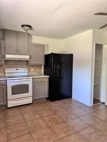 a kitchen with a stove cabinets and refrigerator
